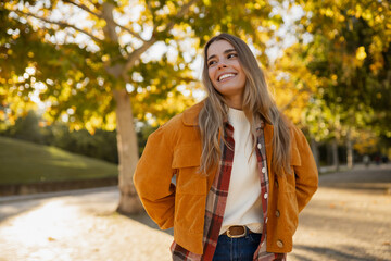 young beautiful blond woman walking in autumn park, stylish , smiling, happy, trendy season warm...