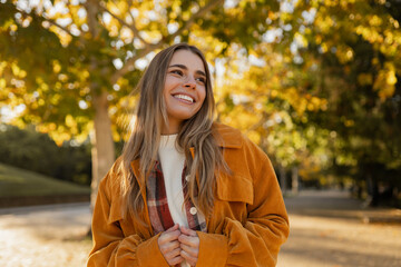 young beautiful blond woman walking in autumn park, stylish , smiling, happy, trendy season warm...