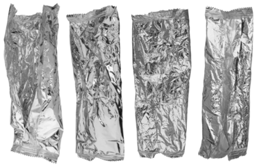 Set of silver shiny aluminium coated metallized polymer wrapping film crumpled and wrinkled, against a transparent background