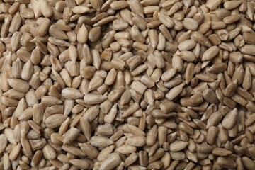 Peeled sunflower seeds as background, closeup view