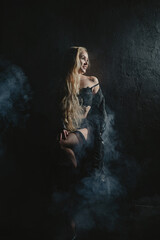 Fototapeta premium Long-haired blonde woman posing in lingerie. 
