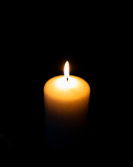 Burning candles on black background with mysterious Halloween atmosphere