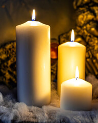 Burning candles on black background with mysterious Halloween atmosphere