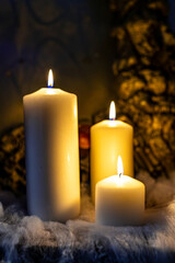Burning candles on black background with mysterious Halloween atmosphere