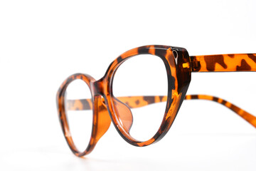 Close up view of a pair of  pretty wonen's glasses with a leopardprint frame isolated on a plain white background. Copy space. No people.