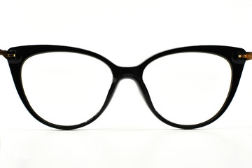 Rear view looking through a pair of pretty cat-eye shape wonen's glasses with a black frame isolated on a plain white background. Copy space. No people.