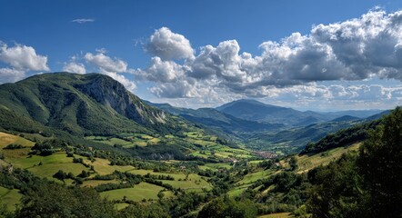 Obraz premium Breathtaking Vista Over Genga, Italy: A Glimpse of Countryside and Mountains Under a Blue Sky