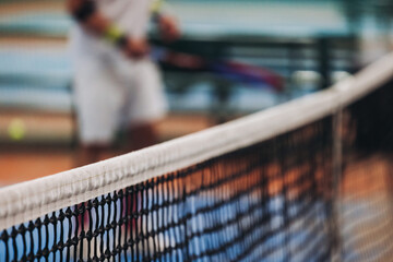 Tennis tournament championship on outdoor clay court with net, professional athletes play in motion with rackets serve tennis ball during tennis match game, tennis training in a sunny day on a stadium