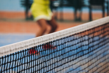 Tennis tournament championship on outdoor clay court with net, professional athletes play in motion with rackets serve tennis ball during tennis match game, tennis training in a sunny day on a stadium