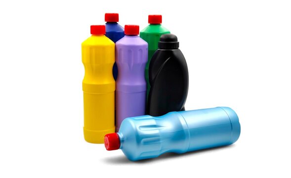 Photo of an assortment of colorful detergent bottles in various colors, isolated on white background.