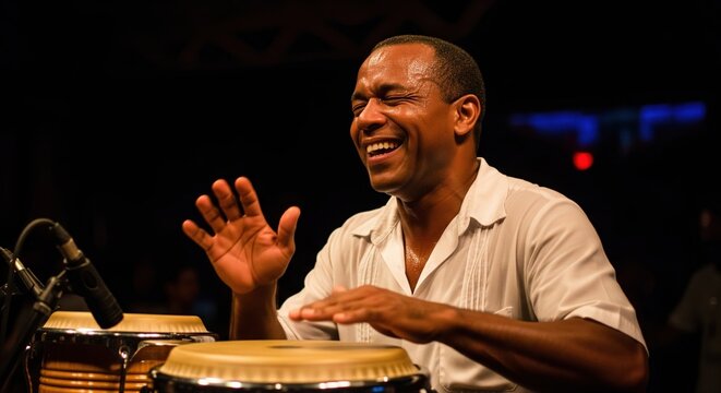 Happy African musician joyfully playing the conga drums during a live music performance on stage