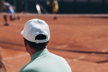 Tennis tournament championship on outdoor clay court with net, professional athletes play in motion with rackets serve tennis ball during tennis match game, tennis training in a sunny day on a stadium