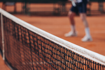 Tennis tournament championship on outdoor clay court with net, professional athletes play in motion...