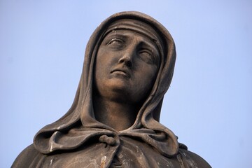 Catholic artwork: Close up portrait of a crying Mary statue (Madonna, the Holy Virgin Mother in tears) as part of the Calvary statue on Charles Bridge, Prague