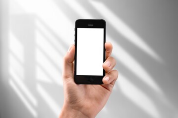 Hand showing modern smartphone with blank screen
