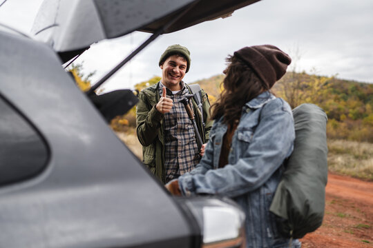 Young couple preparing for outdoor adventure road trip - Powered by Adobe