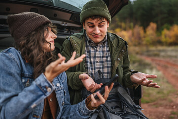 Young couple lost traveling using smart phone navigation