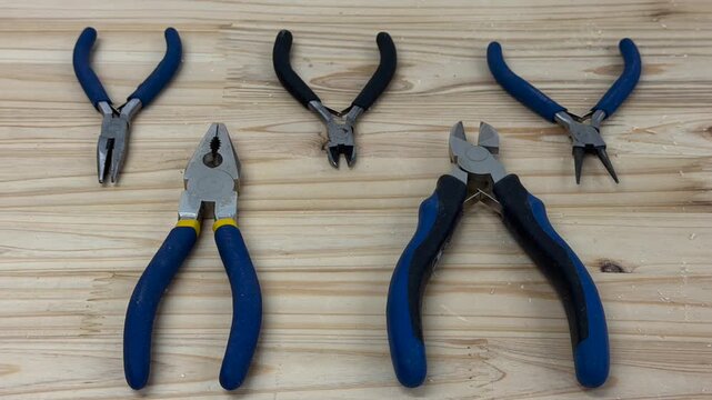 Work tools such as screwdrivers, cutters, or pliers are depicted symbolically. A craftsman's workplace.