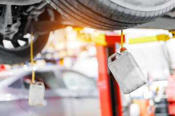 Car service, closeup process changing brake fluid with sunlight