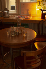 Cozy evening workspace featuring wooden table and soft glow, Relaxing latenight study area with quiet wooden surface illuminated gently by ambient lighting
