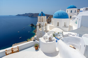 View of the village of Oia in Santorini featuring blue domes and churches, Greece. © GISTEL