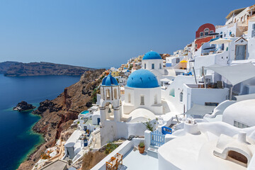 View of the village of Oia in Santorini featuring blue domes and churches, Greece. © GISTEL