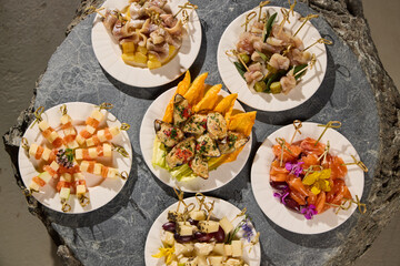 An Exquisite and Diverse Assortment of Elegant Hors dOeuvres Beautifully Arranged on Plates