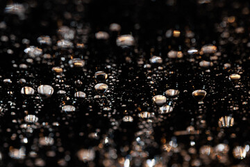 macro close-up of water droplets on a dark background. Mockup for your logo. horizontal wallpaper or web banner.