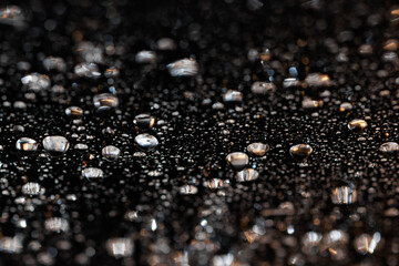 macro close-up of water droplets on a dark background. Mockup for your logo. horizontal wallpaper or web banner.