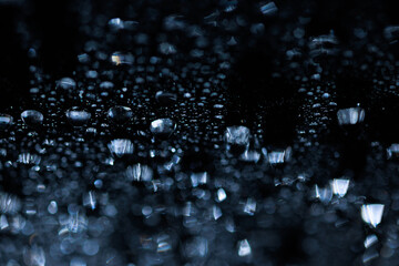 macro close-up of water droplets on a dark background. Mockup for your logo. horizontal wallpaper or web banner.