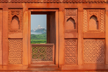A window view of the Taj Mahal from the Agra fort, India.