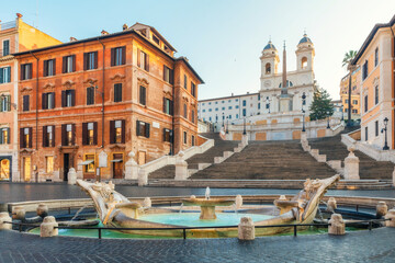 Spanish Steps with Trinita dei Monti church and Fontana della Barcaccia fountain at sunrise and historic buildings in old town of Rome city, Italy. Italian architecture. Travel destination