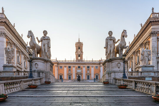 Cordonata staircase leading up to the Piazza del Campidoglio on the Capitoline Hill square with ancient statues and historic architecture in Rome city, Italy, at sunrise. Italian architecture