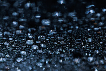 macro close-up of water droplets on a dark background. Mockup for your logo. horizontal wallpaper or web banner.