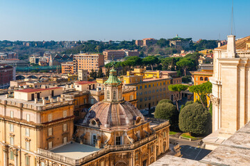 Aerial view of Vatican city with dome rooftop, colorful surrounding buildings and Italian architecture on background. Travel landmark in Rome city, Italy. View from St. Peter's Basilica