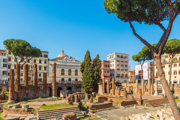 Roman square Largo di Torre Argentina in Rome, Italy. Ancient ruins of four Roman Republican temples and Pompey's Theatre surrounded by colorful buildings. Italian architecture. Archaeological site