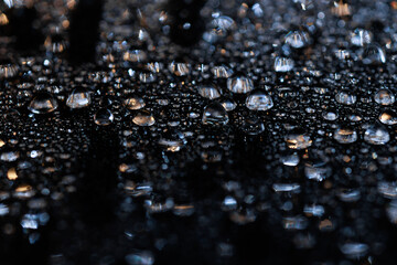 macro close-up of water droplets on a dark background. Mockup for your logo. horizontal wallpaper or web banner.