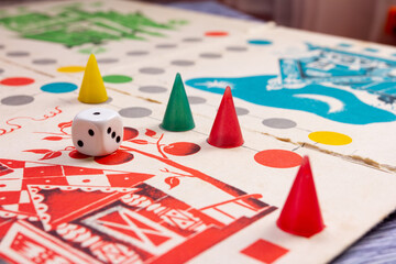 children's game with colorful chips and a numbered cube