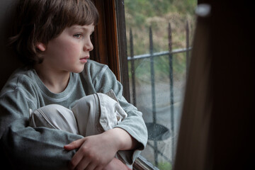 Sad Depressed Boy Young Male Child Looking Out of a Window