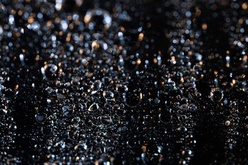 raindrops on a dark background.water drops on glass in close-up. Abstract dark background. Mockup for your logo. horizontal wallpaper or web banner.