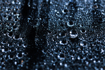 macro close-up of water droplets on a dark background. Mockup for your logo. horizontal wallpaper or web banner.
