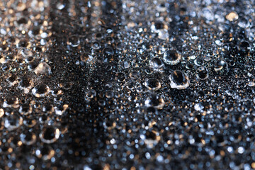 raindrops on a dark background.water drops on glass in close-up. Abstract dark background. Mockup for your logo. horizontal wallpaper or web banner.