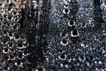 macro close-up of water droplets on a dark background. Mockup for your logo. horizontal wallpaper or web banner.