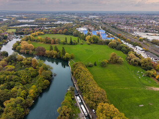 Naklejka premium Elevated capture of the River Thames at Reading in Berkshire, UK, showing the Caversham Weir and surrounding parks