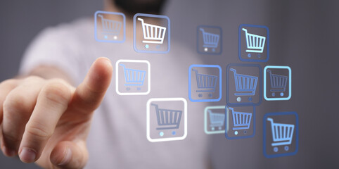 Fototapeta premium Person interacting with shopping cart icons representing online commerce, retail, and e-business. Modern technology and digital shopping experie