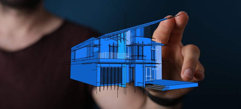 Conceptual image of a person's hand interacting with a blue architectural house blueprint, symbolising design and planning.