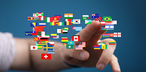 A hand touching an interconnected network of country flags, symbolizing global unity, international...
