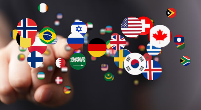 Diverse flags representing countries touch a finger. This photo conveys global unity, connection, travel, international relations, and the conce
