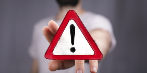 High-impact image of a hand presenting a warning sign. Perfect for conveying urgency, risk, and...