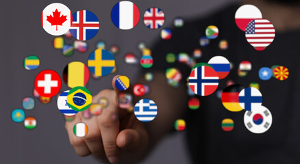Hand interacting with floating flags representing different countries, symbolizes global...